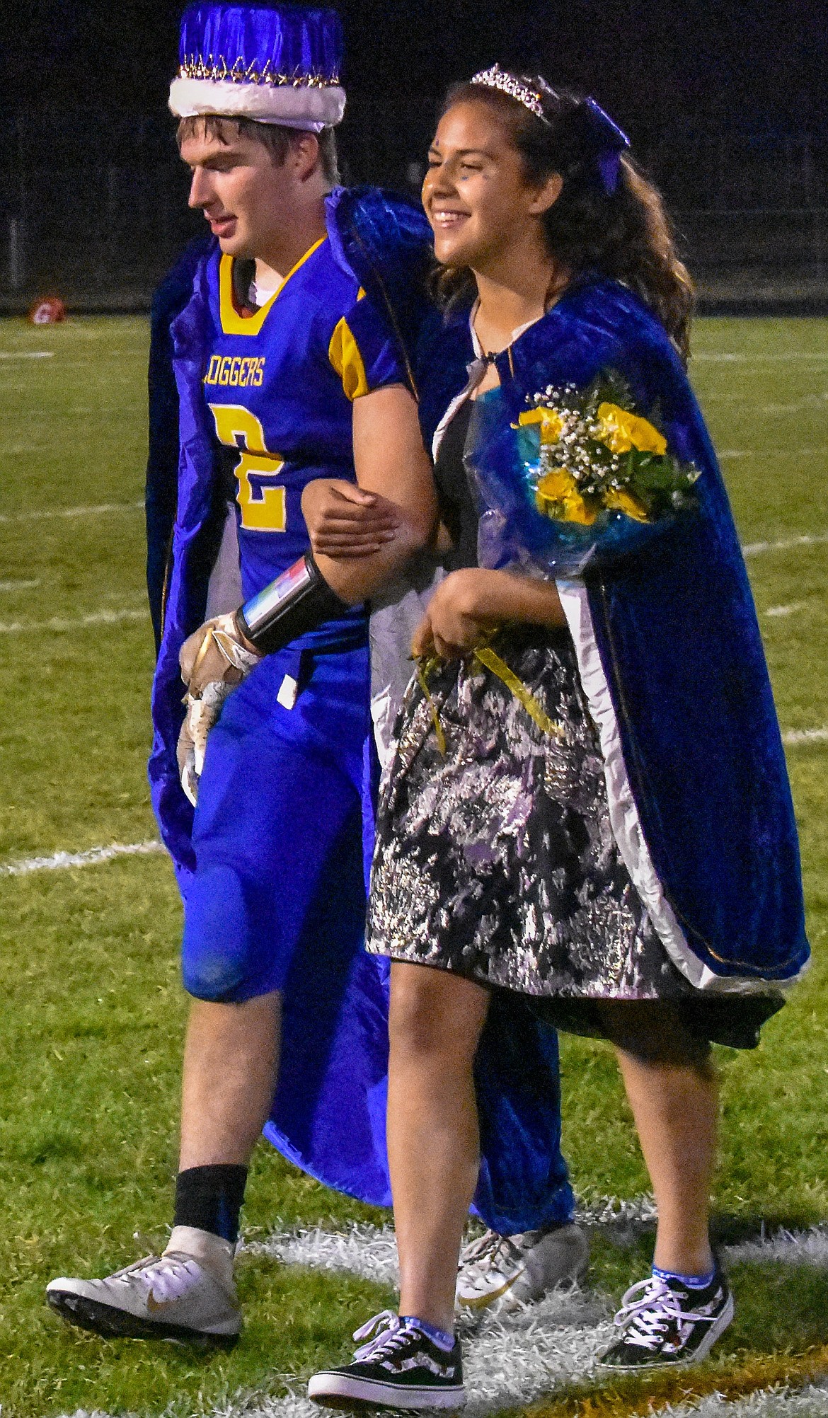 Libby High School homecoming king and queen JJ Davis and Bella Hollingsworth walk off the field after being crowned Friday during halftime of Libby&#146;s 42-14 win over Browning. (Ben Kibbey/The Western News)