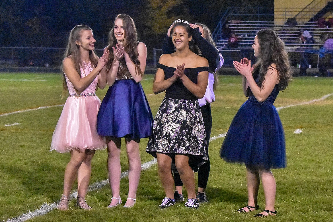Junior Ashlynn Monigold crowns senior Bella Hollingsworth homecoming queen Friday during halftime of Libby&#146;s 42-14 win over Browning as fellow seniors Linsey Walker, Samantha Miller and Emma Gruber congratulate her. (Ben Kibbey/The Western News)