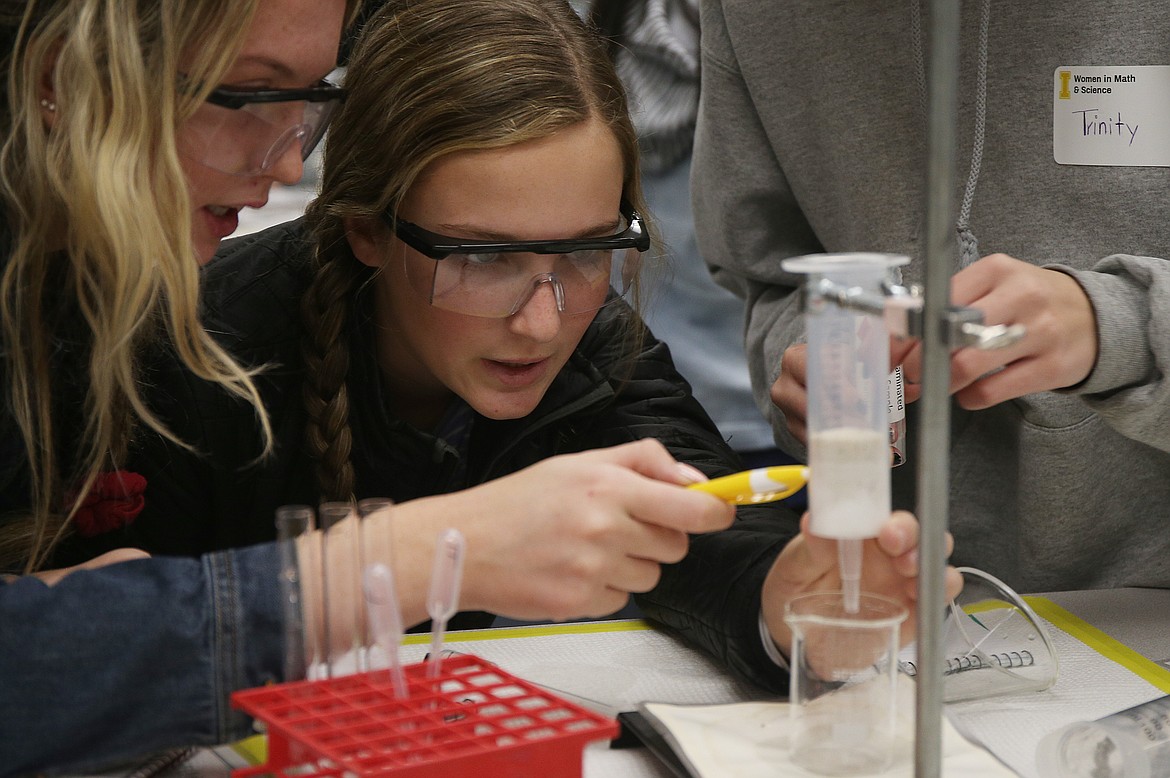 Lake City High School sophomore Brenna Hawkins, left, and Coeur d&#146;Alene High School sophomore Adalyn Curtis closely watch their water sample filtrate through sand during a hands-on water filtration activity Tuesday morning at University of Idaho&#146;s 10th annual Women in Math and Science event. (LOREN BENOIT/Press)