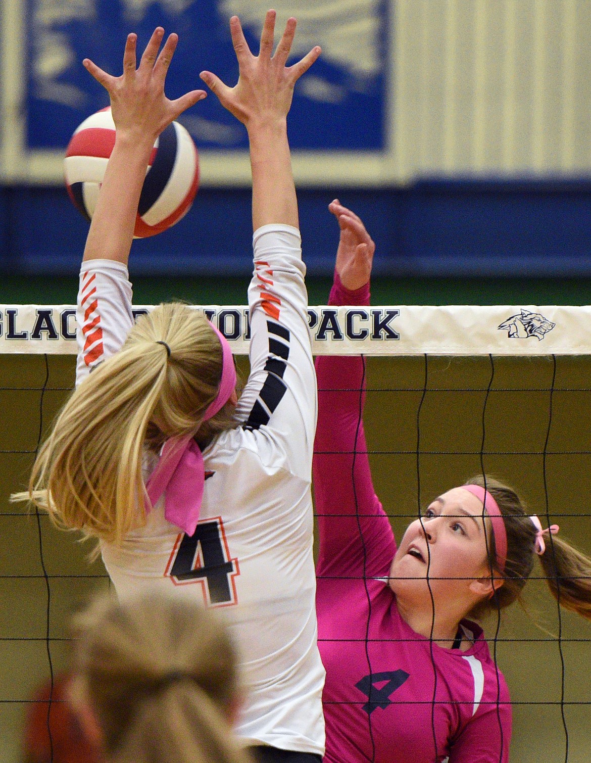 Glacier's Kacey Hill (4) goes for a kill against Flathead's Jaylyn Fitch (4) during crosstown volleyball at Glacier High School on Thursday. (Casey Kreider/Daily Inter Lake)