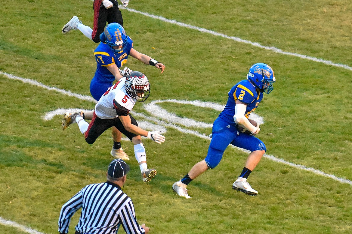 Libby senior running back JJ Davis takes a pass from junior quarterback Jeff Offenbecher for a 30 yard gain early in the first quarter of the Loggers' 42-14 homecoming win over Browning Friday. (Ben Kibbey/The Western News)