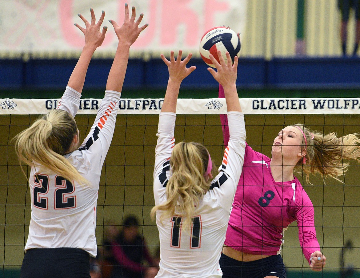 Glacier's Aubrie Rademacher (8) goes for a kill against Flathead's Julia Burden (22) and Hannah O'Dell (11) during crosstown volleyball at Glacier High School on Thursday. (Casey Kreider/Daily Inter Lake)