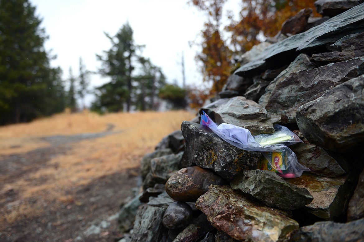 Two plastic bags containing instructions, papers to sign your name and writing utensils are tucked into a rock cairn for the Lone Pine/Herron Park Challenge at Lone Pine State Park on Tuesday, Oct. 2. The Lone Pine/Herron Park Challenge asks participants to reach the top of either park 30 times in the 31 days of October and to document each visit on social media. (Casey Kreider/Daily Inter Lake)