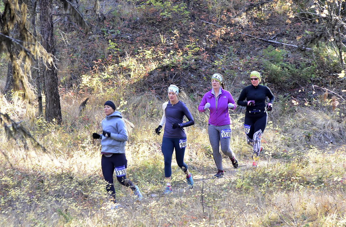 A group of runners begin the half marathon race of the Whitefish Trail Legacy Run Sunday morning on the Whitefish Trail. (Heidi Desch/Whitefish Pilot)
