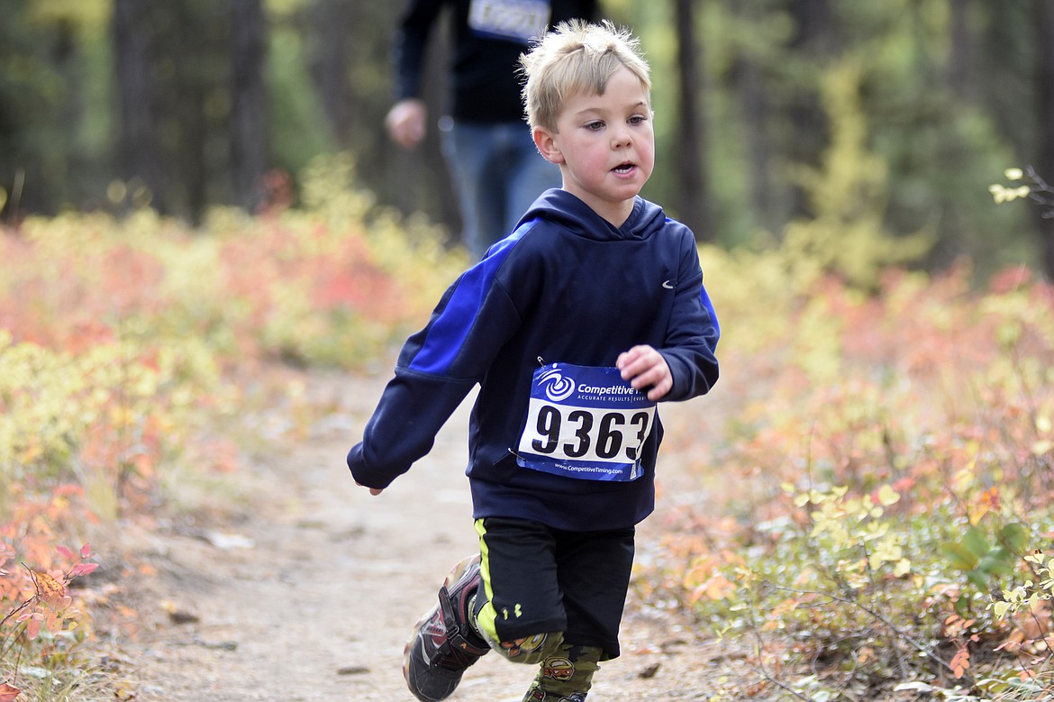 Tanner Forthofer, 5, begins the fun run during the Whitefish Trail Legacy Run Sunday morning. (Heidi Desch/Whitefish Pilot)