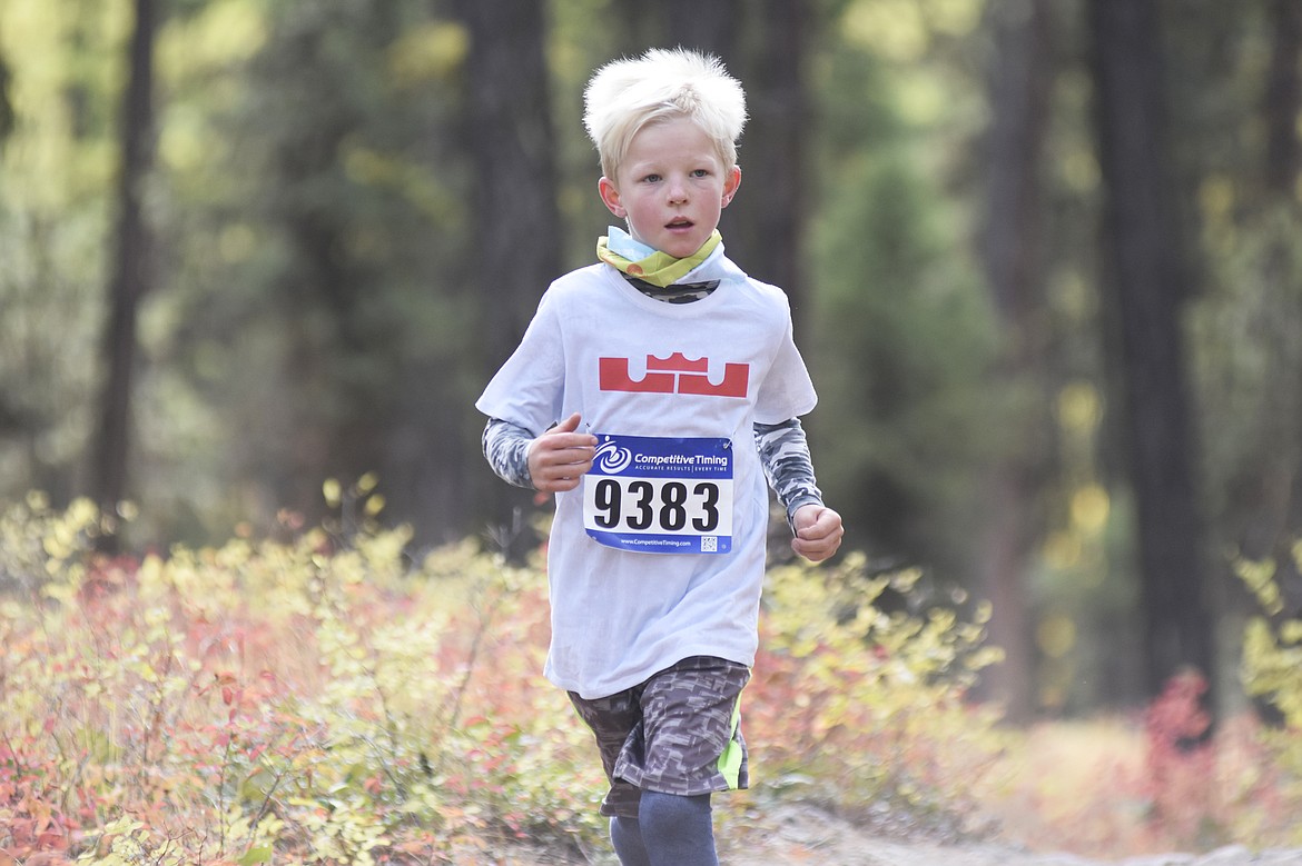 Mason O&#146;Neil, 9, runs in the 2-mile fun run on the Whitefish Trail Sunday morning during the Whitefish Trail Legacy Run. (Heidi Desch/Whitefish Pilot)