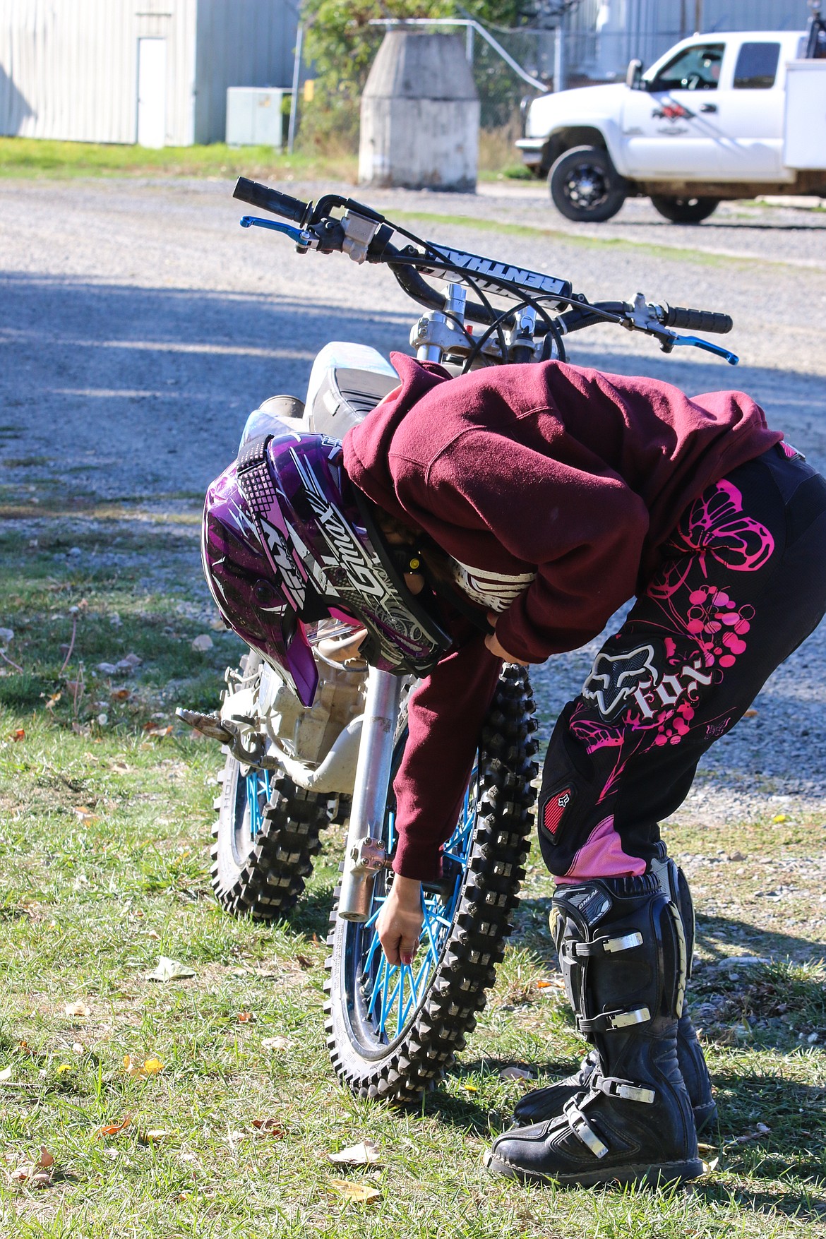 Photo by MANDI BATEMANHannah facha checks her spokes as part of the pre-ride safety check that should always be performed.