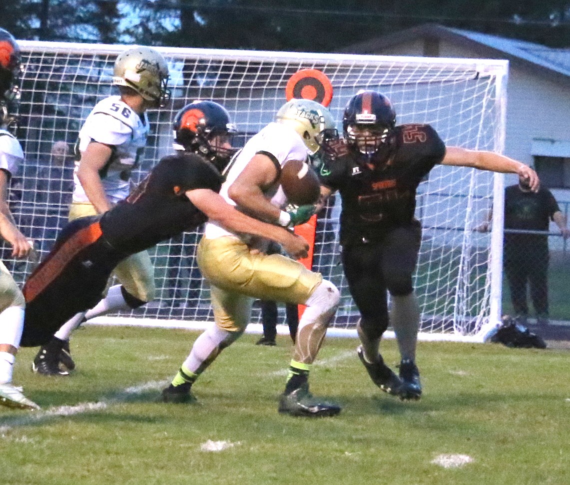 (Photo by MARY MALONE)
Bradley O&#146;Brien, left, and Cole Thompson converge on a tackle in earlier season action. The Spartans had a comeback to remember on Friday.