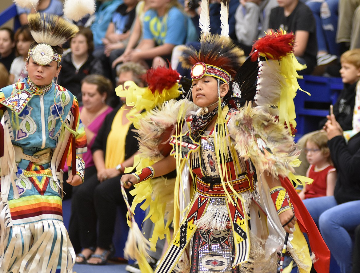 Joshua Skunk Cap, right, and Taymond Stiffarm dance as part of the &#147;grand entry dance&#148; Thursday morning in the gym at Olney-Bissell School for students during a presentation by the Pikuni Legacy Dance Troupe from Browning. The dance group visited as part of the school&#146;s recognition of American Indian Heritage Day, which occurred on Friday and is designated as an observance to commemorate the state's American Indians and &#147;their valued heritage and culture.&#148; Olney-Bissell's Debbie Briggs said the presentation was part of a larger curriculum of activities at the school designed to teach students about American Indian culture. (Heidi Desch/Whitefish Pilot)