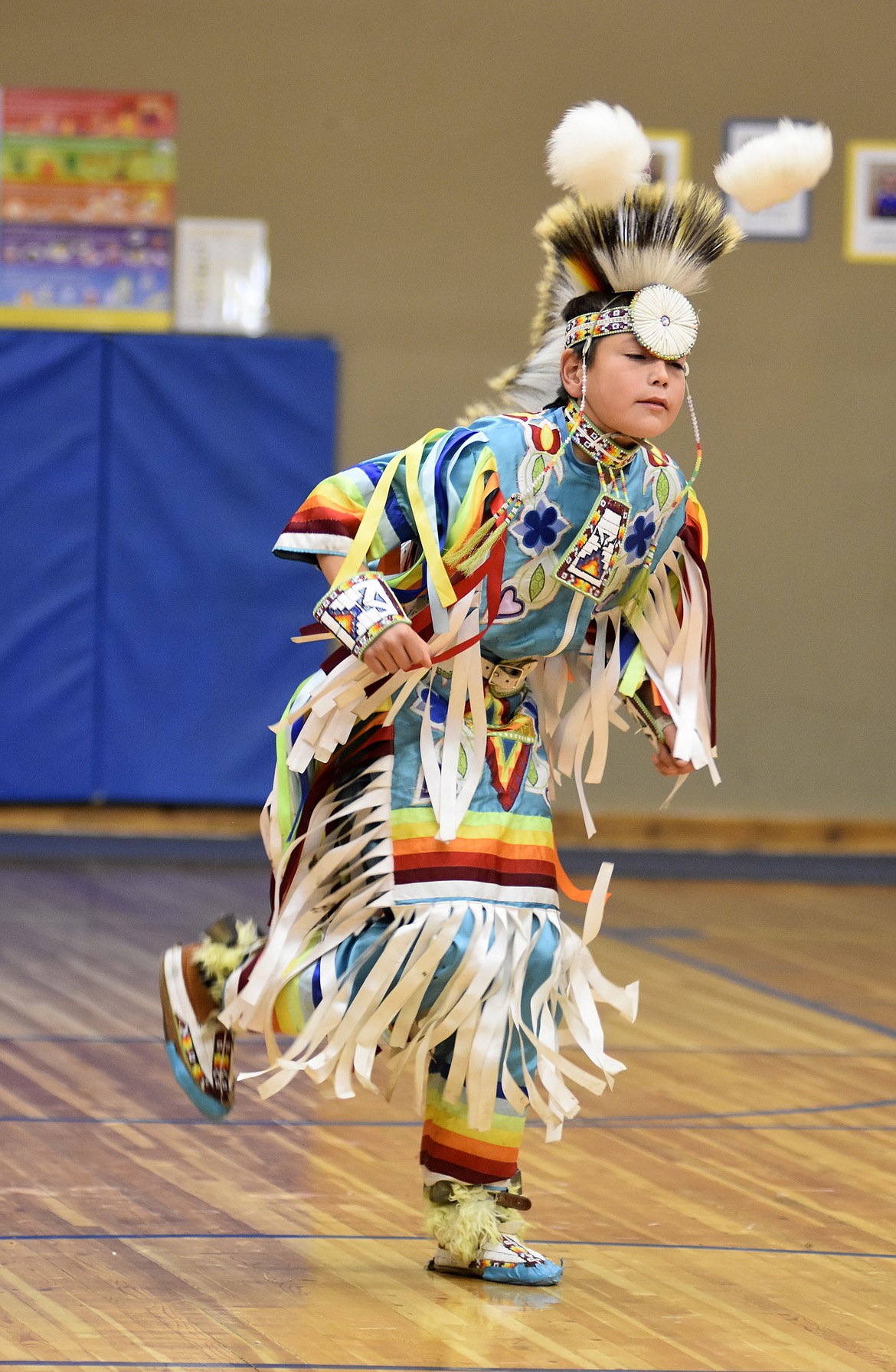 Taymond Stiffarm, a grass dancer, performs for students Thursday morning at Olney-Bissell School during a presentation by the Pikuni Legacy Dance Troupe from Browning. (Heidi Desch/Whitefish Pilot)