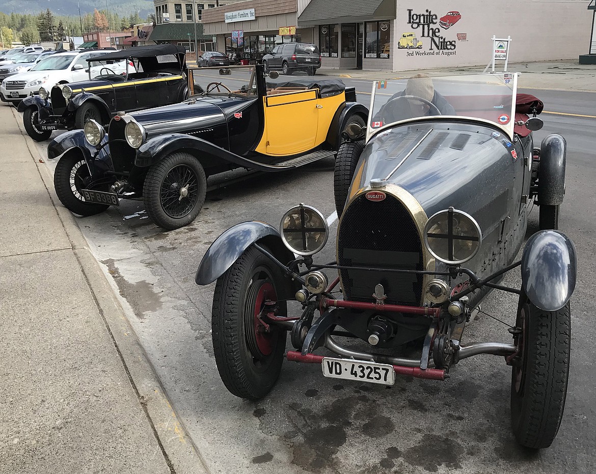 RIGHT: Three of seven Bugattis being driven across the United States line Mineral Avenue in Libby Monday.