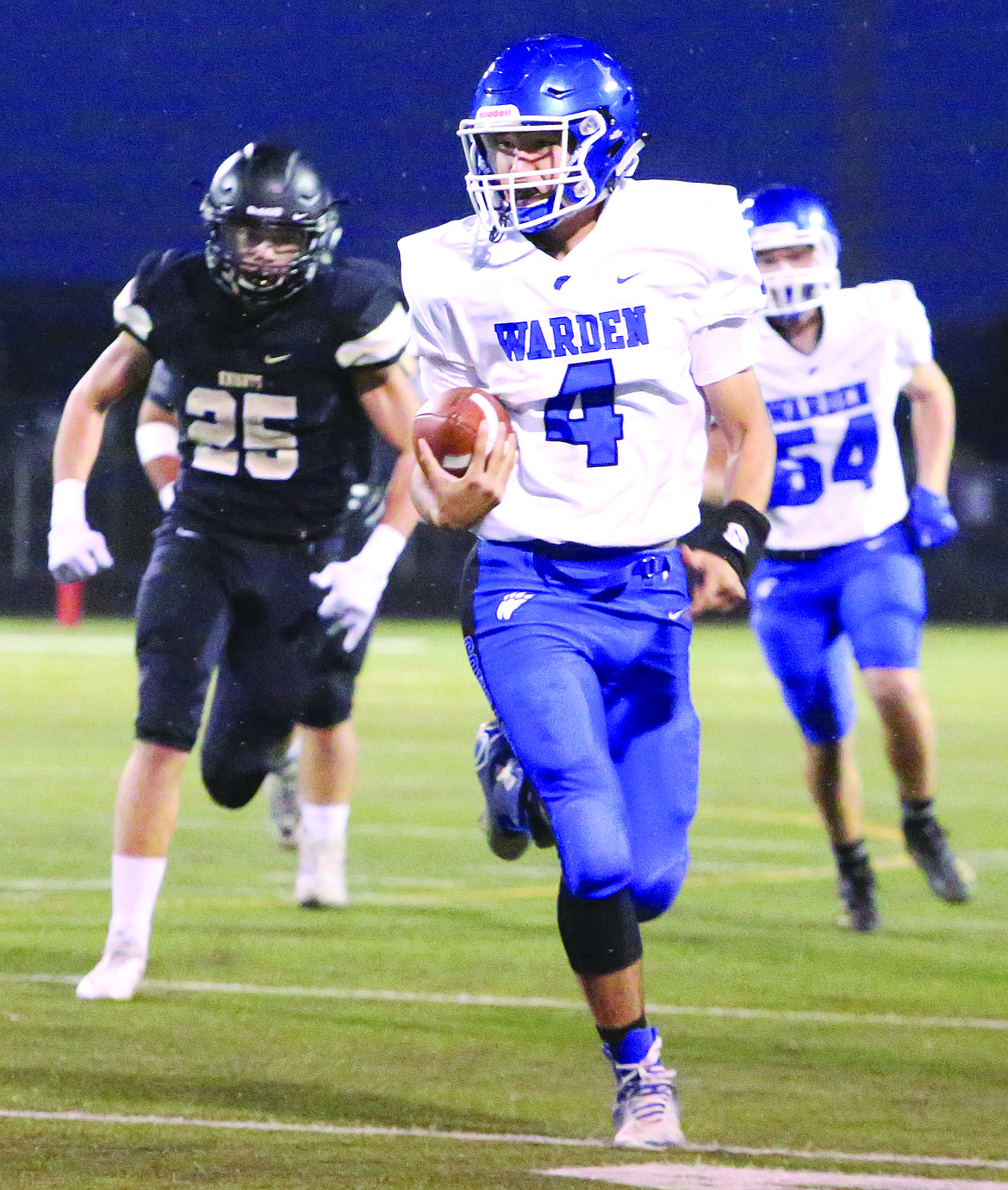 Connor Vanderweyst/Sun Tribune - Warden quarterback Ryan Arredondo tucks and runs with the ball against Royal.