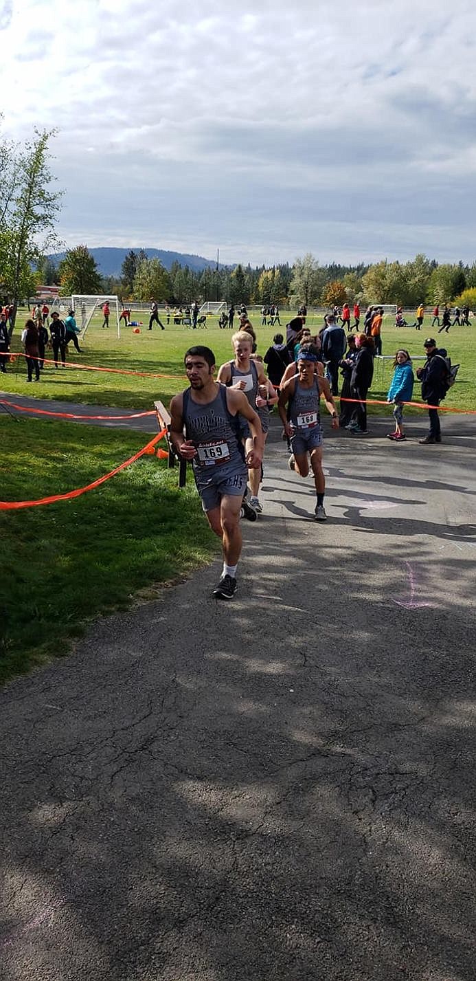 Photo by STEVEN DONN
Oscar Valladares, Justin Mendenhall, and Conner Strickert race around the turn.