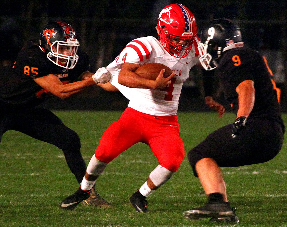 Rodney Harwood/Sun Tribune - Ephrata defensive back Valerio Placido-Barajas (85) and Mac Laird (9) take down Othello running back Isaac Barragan (4) during the first quarter of Friday night's CWAC game at Kiwanis Field.