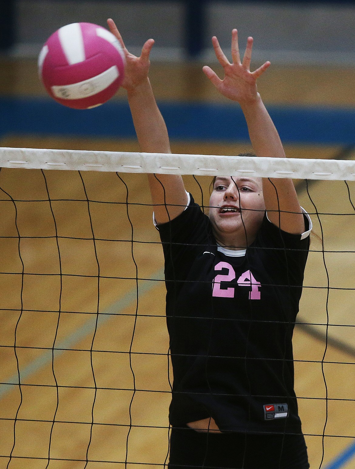 Maddy John of Post Falls High goes for a block against Coeur d&#146;Alene.