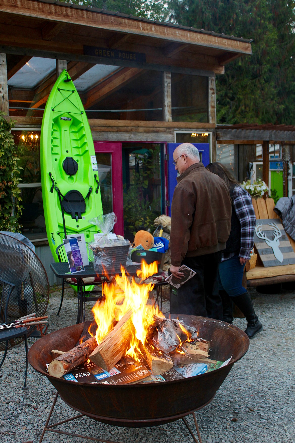 Chamber supporters peruse the different live auction items while staying warm next to the fire.