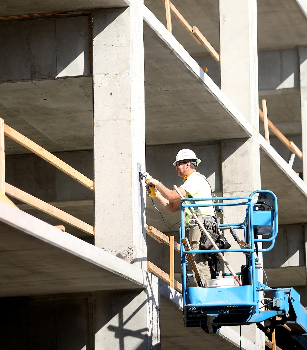 Ron Coddington with LaRiviere Construction smooths and patches a pillar last week at the new downtown parking garage. (LOREN BENOIT/Press)