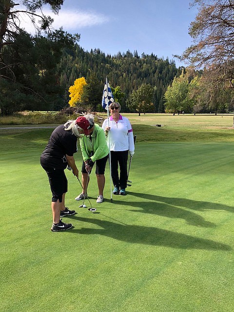 Mirror Lake ladies golfers Karen English, Kinda Rupley, and Linda Bogden putting out on Hole 8.
Photo by ADA GARDINER