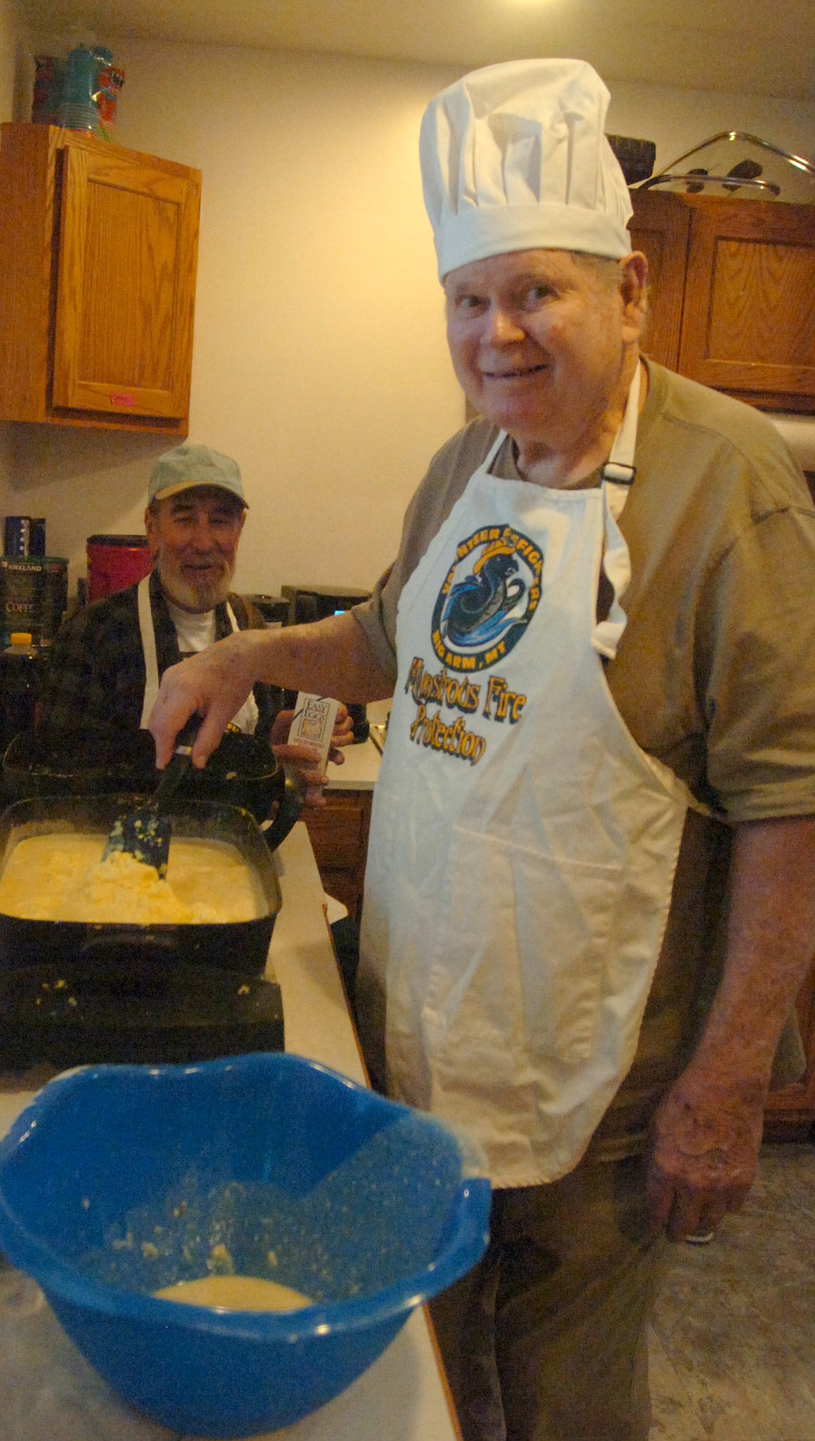 Roger Rogers was the scrambled egg cook during the Big Arm Association breakfast last Saturday morning at the former Big Arm School. Roger is on the association&#146;s board of directors. Volunteer Daniel Greene is in the background.