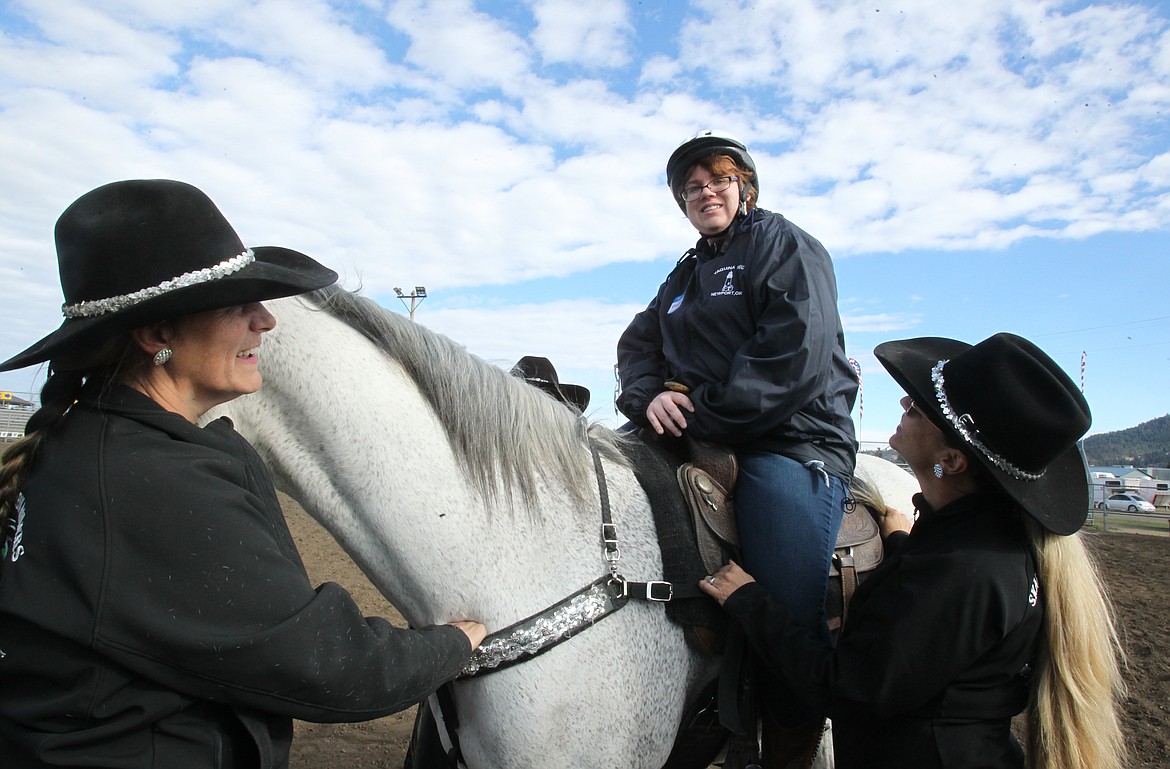 Madison Brinson, 21, of Hayden, enjoys riding Pistol the horse Saturday morning with the help of Skagit Rein Riders Teri Peth, left, and Jill Isaacson during the Coeur d'Alene Rascal Rodeo at the Kootenai County Fairgrounds. The Rascal Rodeo gave people of all ages and disabilities the chance to try some Western activities and have some cowboy fun. &quot;I love horses,&quot; Brinson said. &quot;I always wanted to have one of my own.&quot; (DEVIN WEEKS/Press)