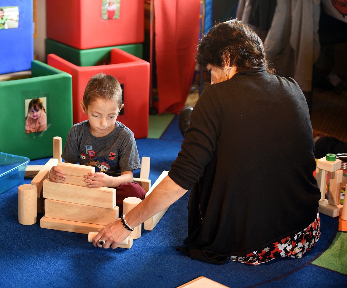 SUSAN MATOVICH of the Communications Program works with CJ Mobley at the Flathead Special Education Cooperative on Thursday morning in Kalispell. (Brenda Ahearn photos/Daily Inter Lake)