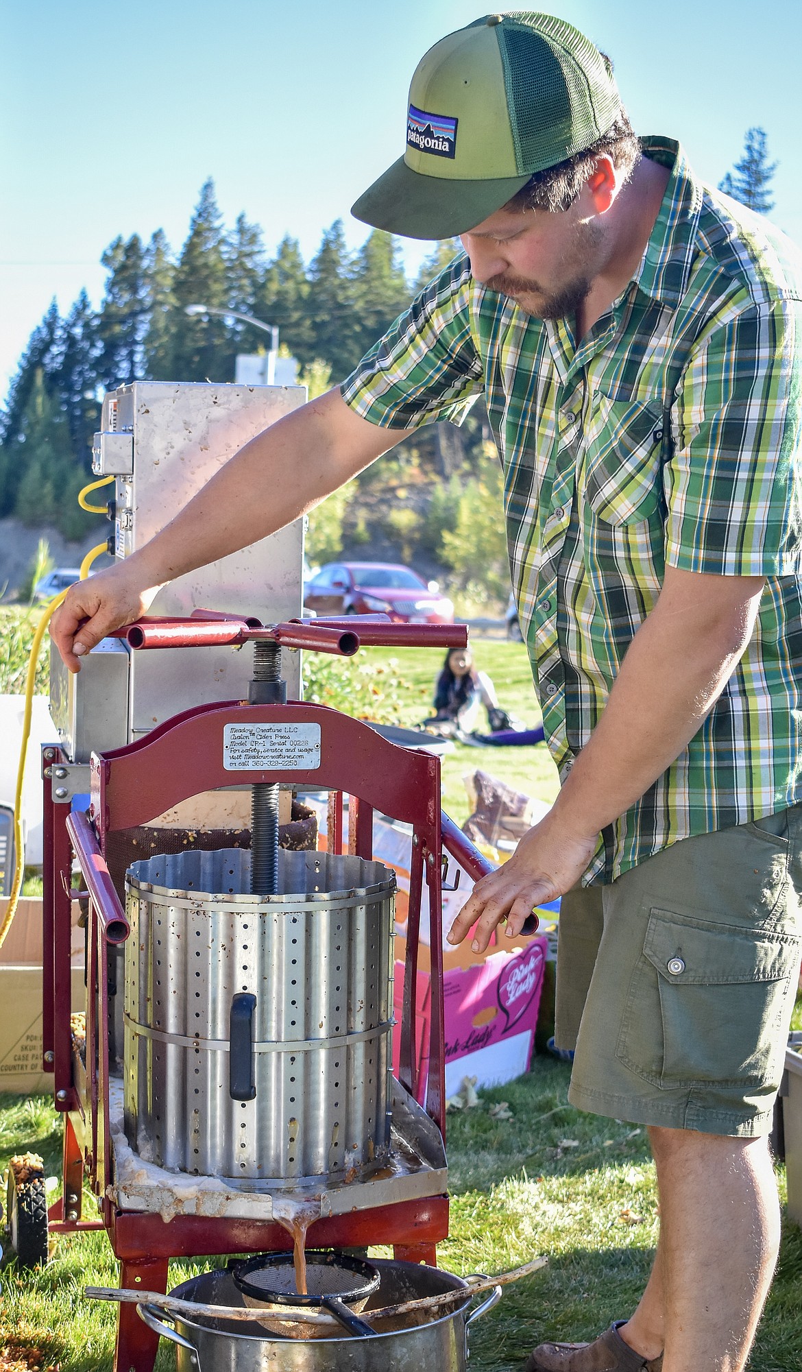 Anthony South, with the Yaak Valley Forest Council, operates the apple press Friday at the Troy Farmer&#146;s Market Apple Festival. (Ben Kibbey/The Western News)