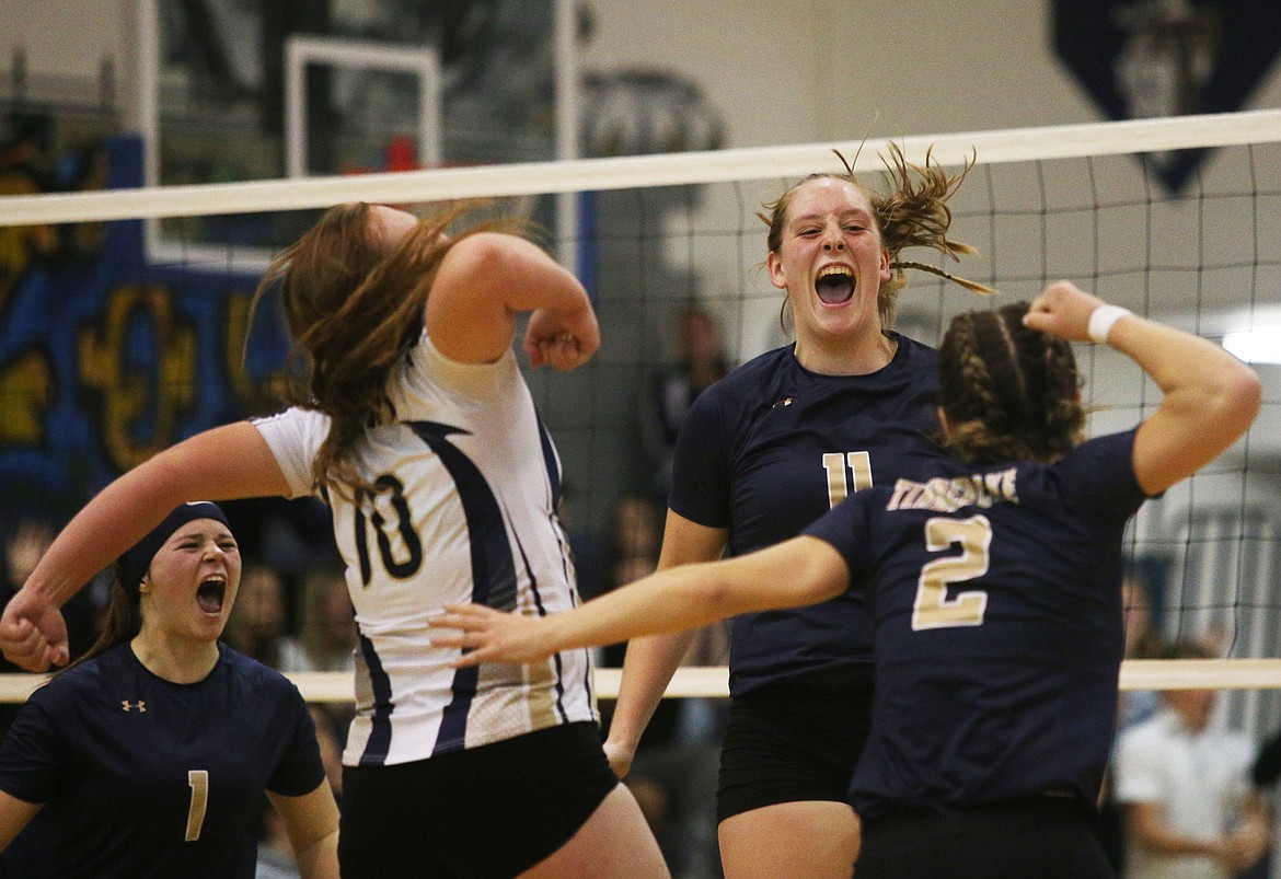 Timberlake&#146;s Brooke Jessen (11), Kyndal Lindley (1), Becca Malloy (10) and McKeeley Tonkin (2) celebrate the Tigers&#146; 25-18, 25-12, 25-21 win over Kellogg for the 3A District 1 volleyball championship Thursday night at Timberlake High School.
LOREN BENOIT/Press