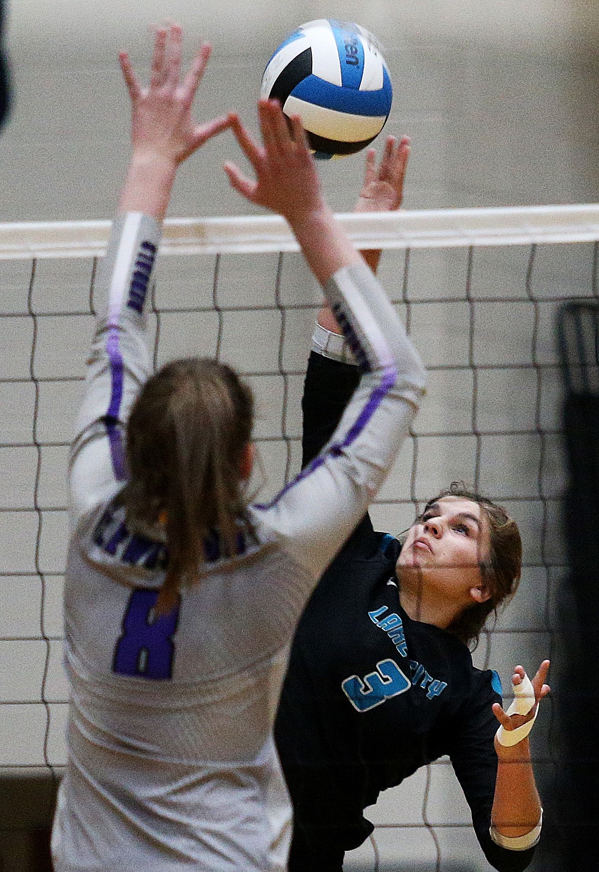 LOREN BENOIT/Press
Lake City outside hitter Ashley Kaufman hits by Lewiston&#146;s Julia Dickeson in Tuesday night&#146;s 5A Region 1 volleyball championship match at Lake City High School.