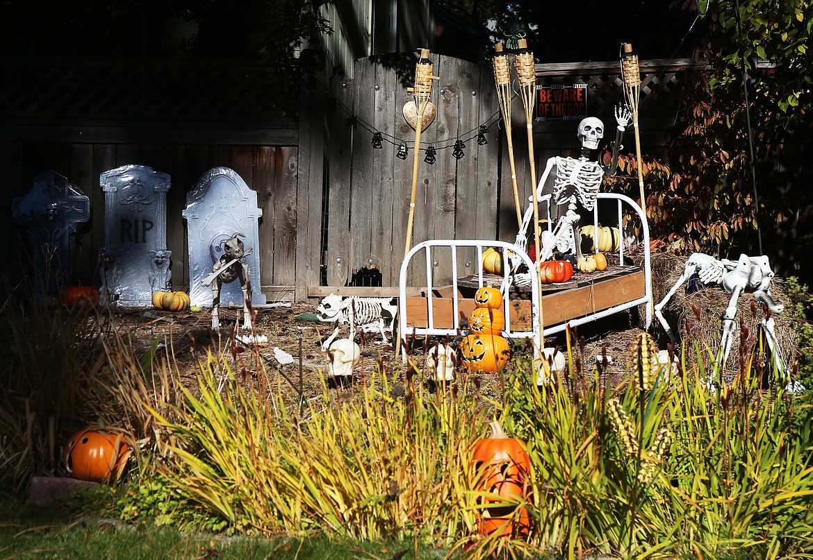 A large Halloween-themed skeleton waves to neighbors nearby along Parkwood Lane. (LOREN BENOIT/Press)