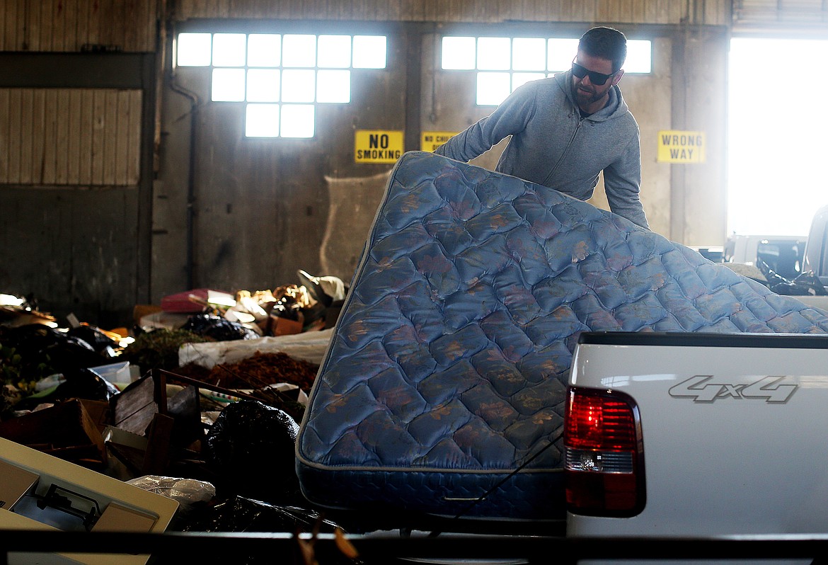 Mike Patterson disposes of a bed at the Ramsey Transfer Station Monday afternoon in Coeur d&#146;Alene. Waste has increased over the past year with the combination of construction activity and waste from the general public.(LOREN BENOIT/Press)