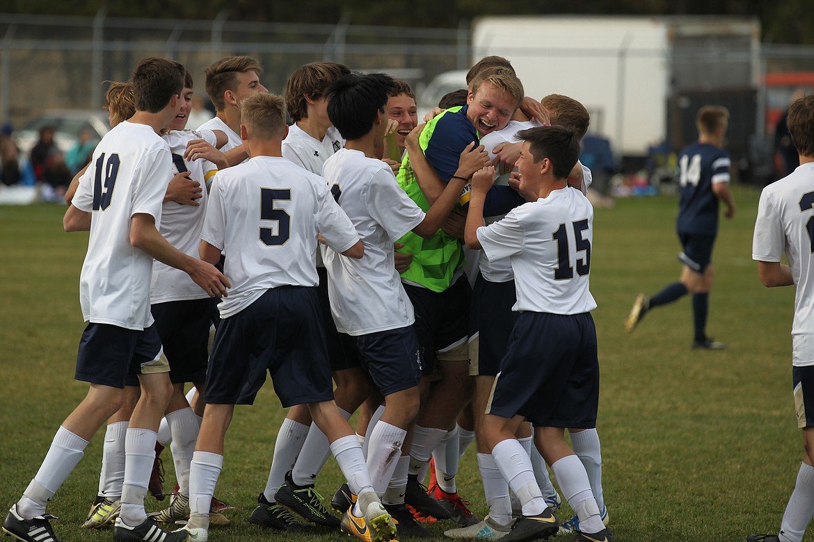 JASON ELLIOTT/Press
Members of the Timberlake High boys soccer team hug goalkeeper Sheldon Kistler, center, after winning the 3A District 1-2 championship on Saturday in Rathdrum.