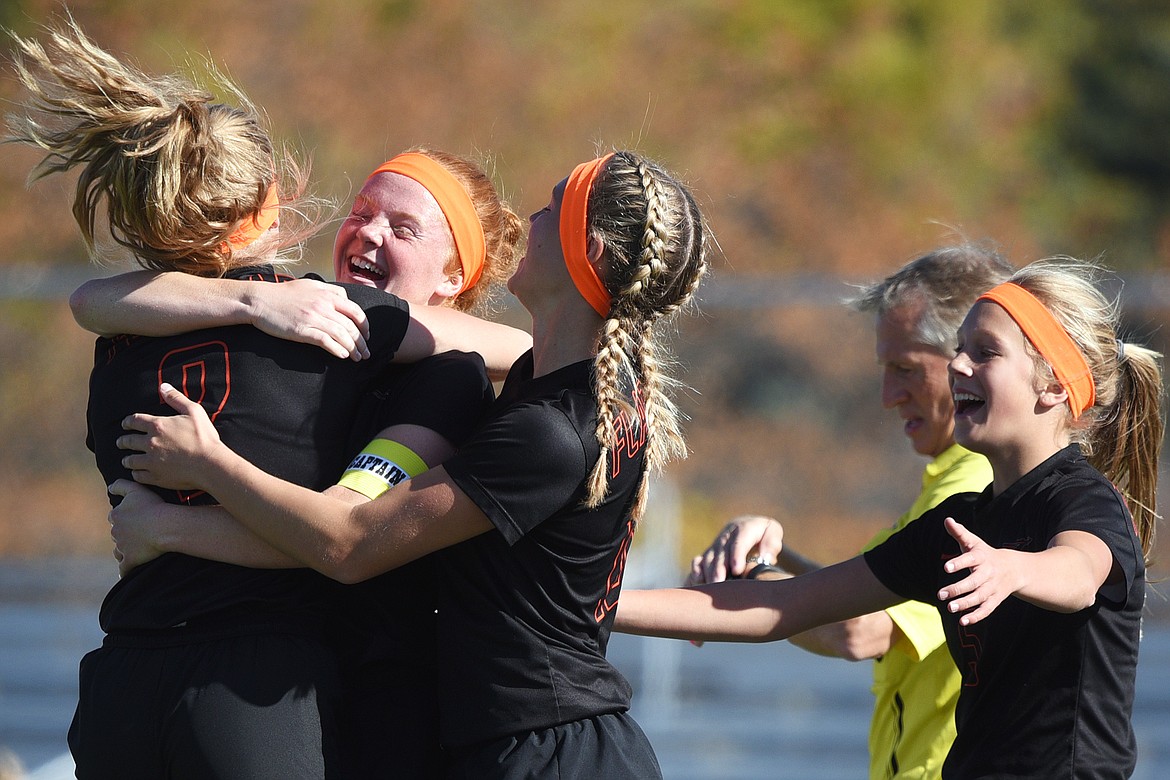 From left, Flathead's Elena Jimenez (2), Skyleigh Thompson (9), Shayenn Thompson (10) and Ellie Hawes (5) celebrate after Skyleigh Thompson's goal in the second half against Helena High at Legends Stadium on Thursday. (Casey Kreider/Daily Inter Lake)