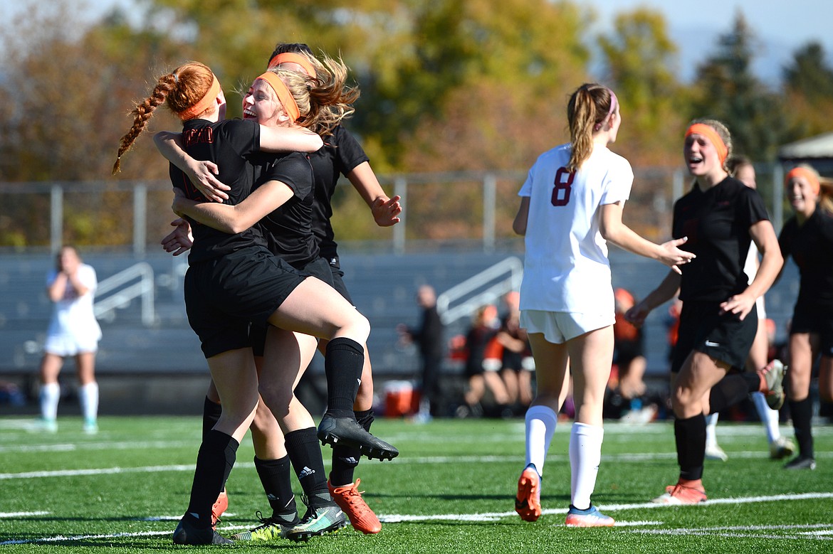 Flathead's Skyleigh Thompson, left, Elena Jimenez, center, and Mathilde Burgaard, rear, celebrate after Jimenez' goal in the second half against Helena High at Legends Stadium on Thursday. (Casey Kreider/Daily Inter Lake)