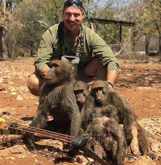 Blake Fischer poses with dead baboons in Namibia in this photo, one of several from an African safari, that he emailed to friends and others after an African safari. Fischer resigned from the Idaho Department of Fish and Game Commission Monday at the request of Gov. Butch Otter.