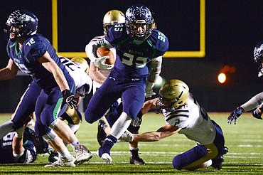 Glacier running back Preston Blain (33) breaks a tackle and heads to the end zone on a third-quarter touchdown run against Missoula Big Sky at Legends Stadium on Thursday. (Casey Kreider/Daily Inter Lake)