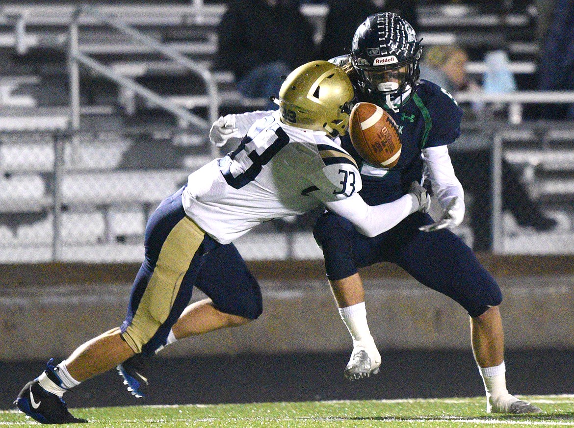 Glacier wide receiver Drew Deck (5) fumbles after being hit by Missoula Big Sky defensive back Dayton Evans (33) on a second-quarter reception at Legends Stadium on Thursday. (Casey Kreider/Daily Inter Lake)