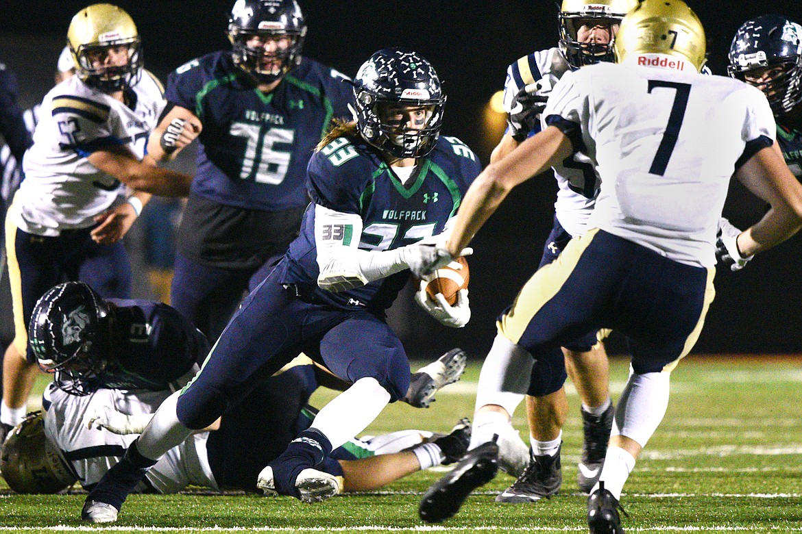 Glacier running back Preston Blain (33) looks for running room in the third quarter against Missoula Big Sky at Legends Stadium on Thursday. (Casey Kreider/Daily Inter Lake)