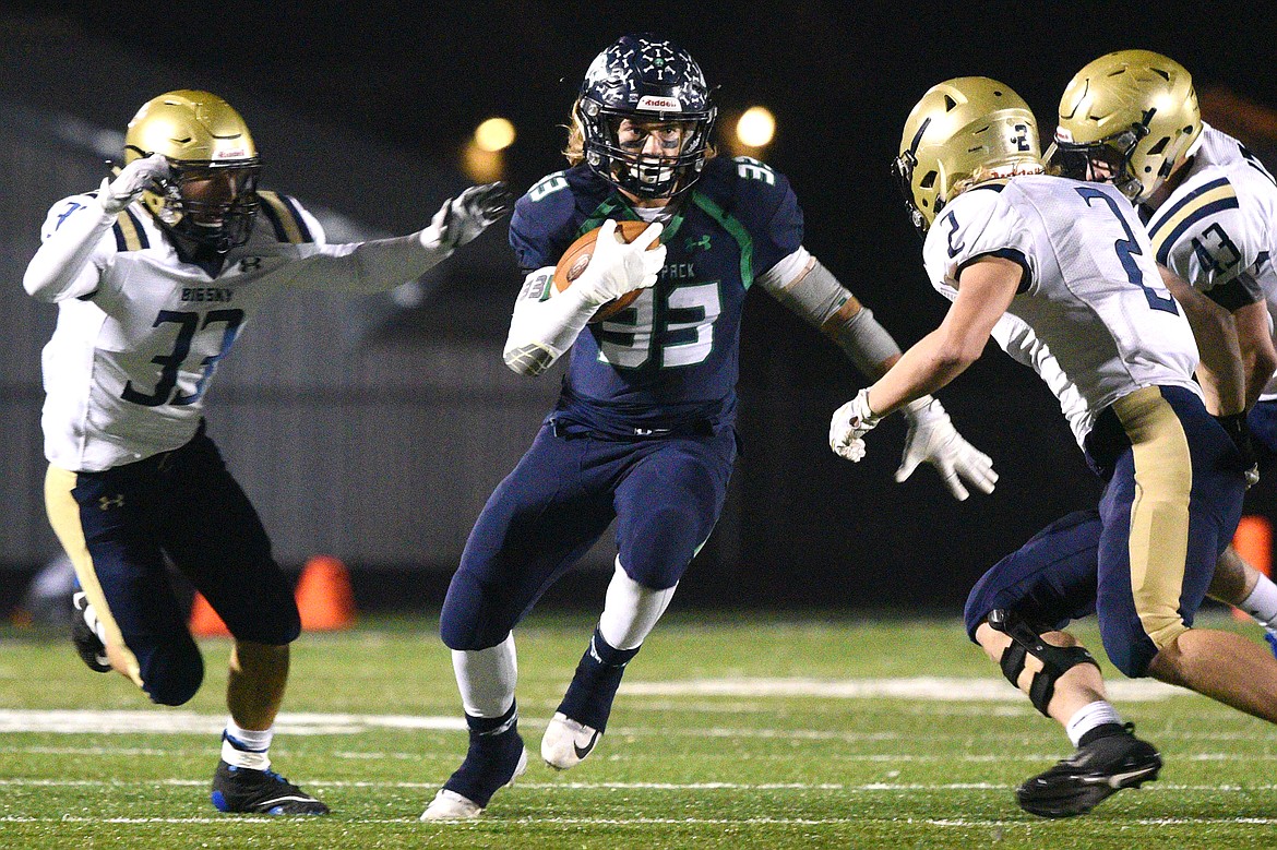 Glacier running back Preston Blain (33) looks for running room in the third quarter against Missoula Big Sky at Legends Stadium on Thursday. (Casey Kreider/Daily Inter Lake)