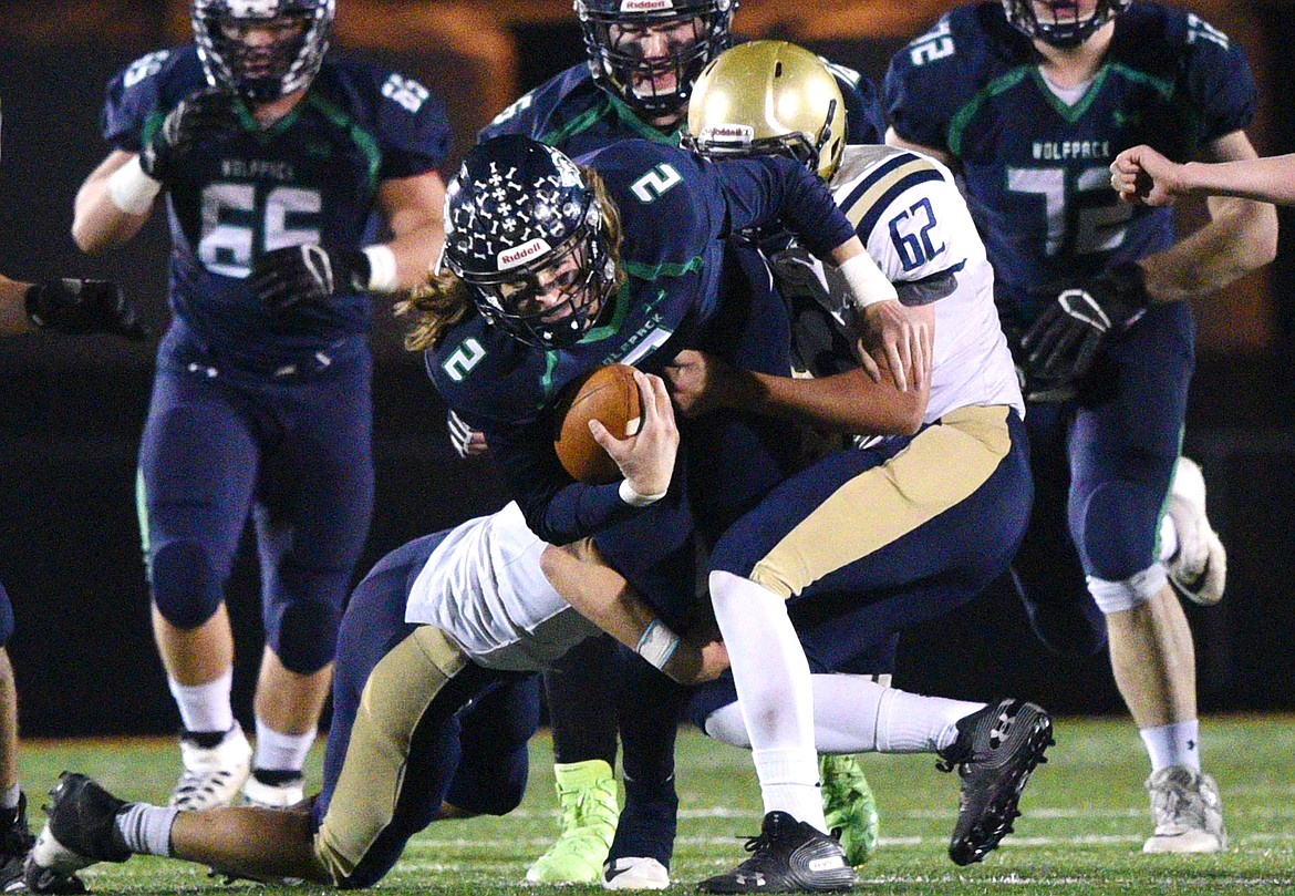 Glacier quarterback Evan Todd (2) is wrapped up after a short scramble in the first half against Missoula Big Sky at Legends Stadium on Thursday. (Casey Kreider/Daily Inter Lake)