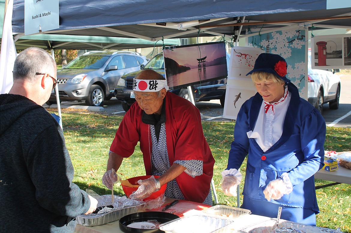 Joel Martin/Columbia Basin Herald
Andy and Beryl Goto of Quincy serve up sushi and English trifle at the Quincy Celebration of Cultures Saturday.