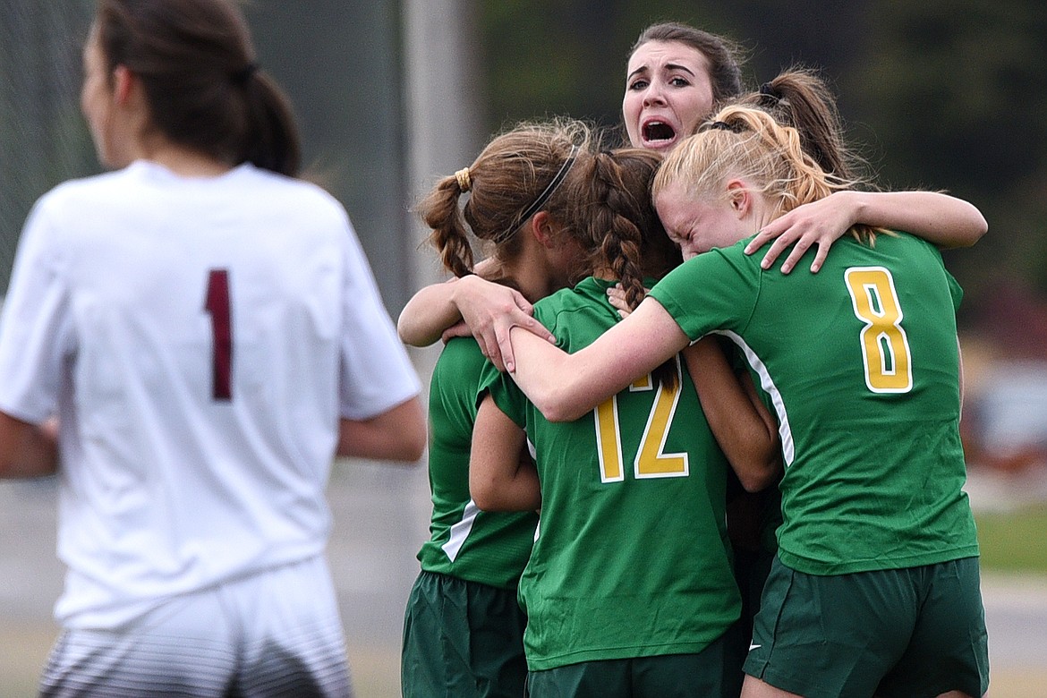 Whitefish teammates celebrate with Olivia Potthoff, rear, after Potthoff scored the game-winning goal in overtime against Hamilton at Smith Fields in Whitefish on Saturday. (Casey Kreider/Daily Inter Lake)