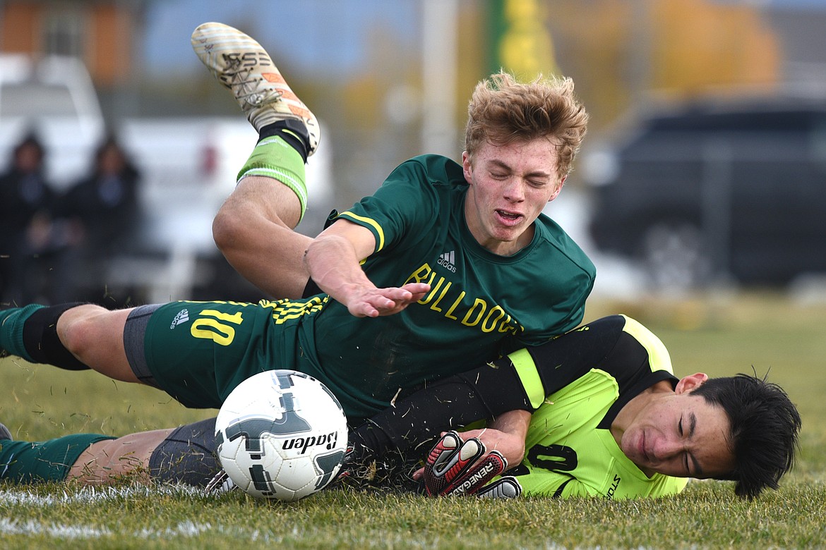 Whitefish's Casey Schneider (10) collides with Livingston goalkeeper Brandon Smith (00) in the second half at Smith Fields in Whitefish on Saturday. (Casey Kreider/Daily Inter Lake)