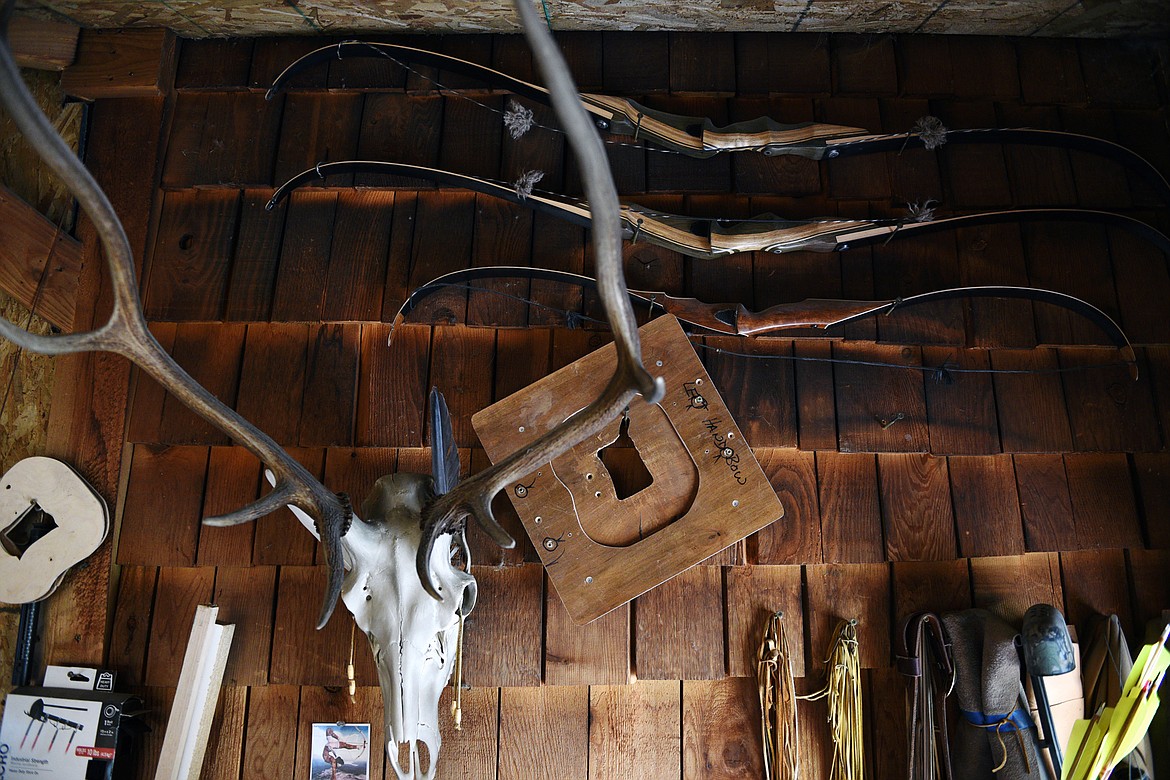 Finished bows hang from a wall in Peter Laffin&#146;s workshop.