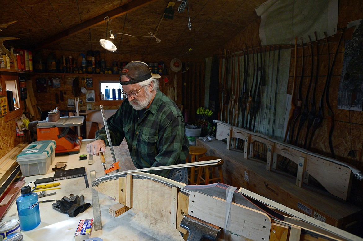 Peter Laffin works on a bow in his workshop.