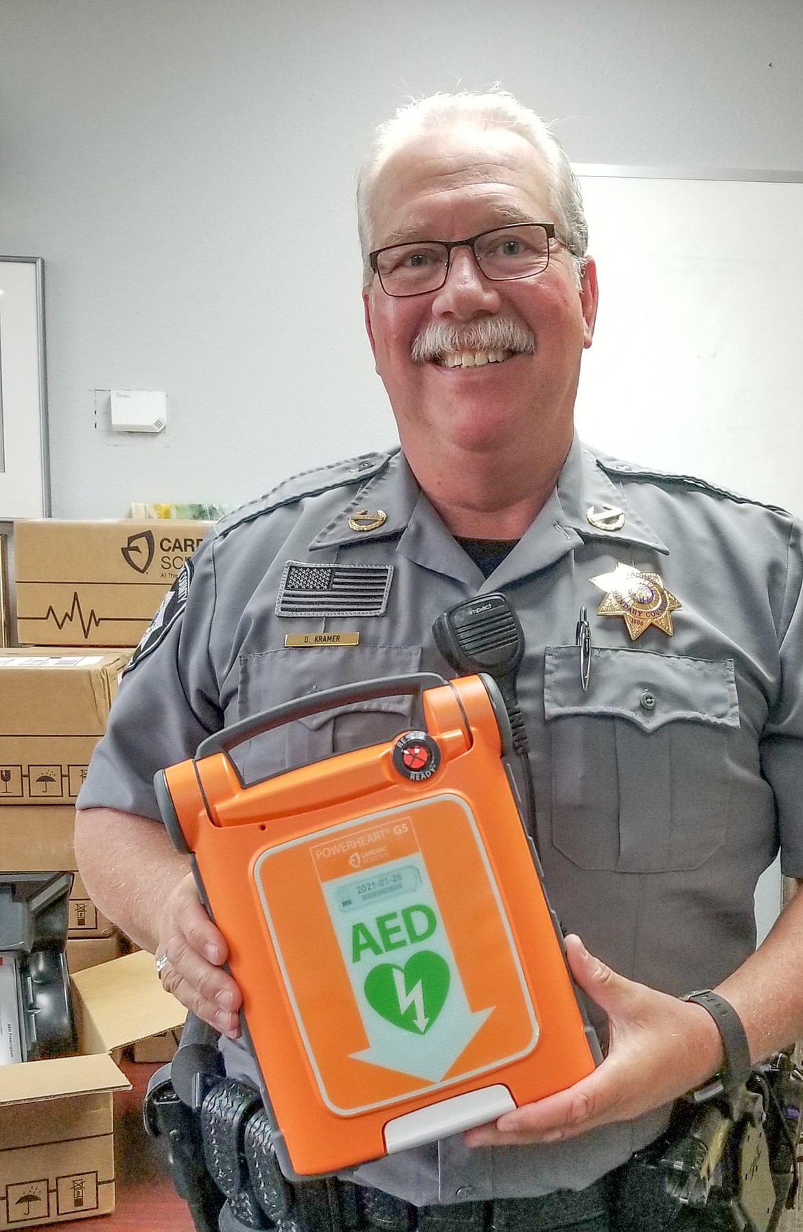 Photo by MANDI BATEMAN
Boundary County Sheriff Dave Kramer holds one of the new AED units that will be assigned to every deputy.