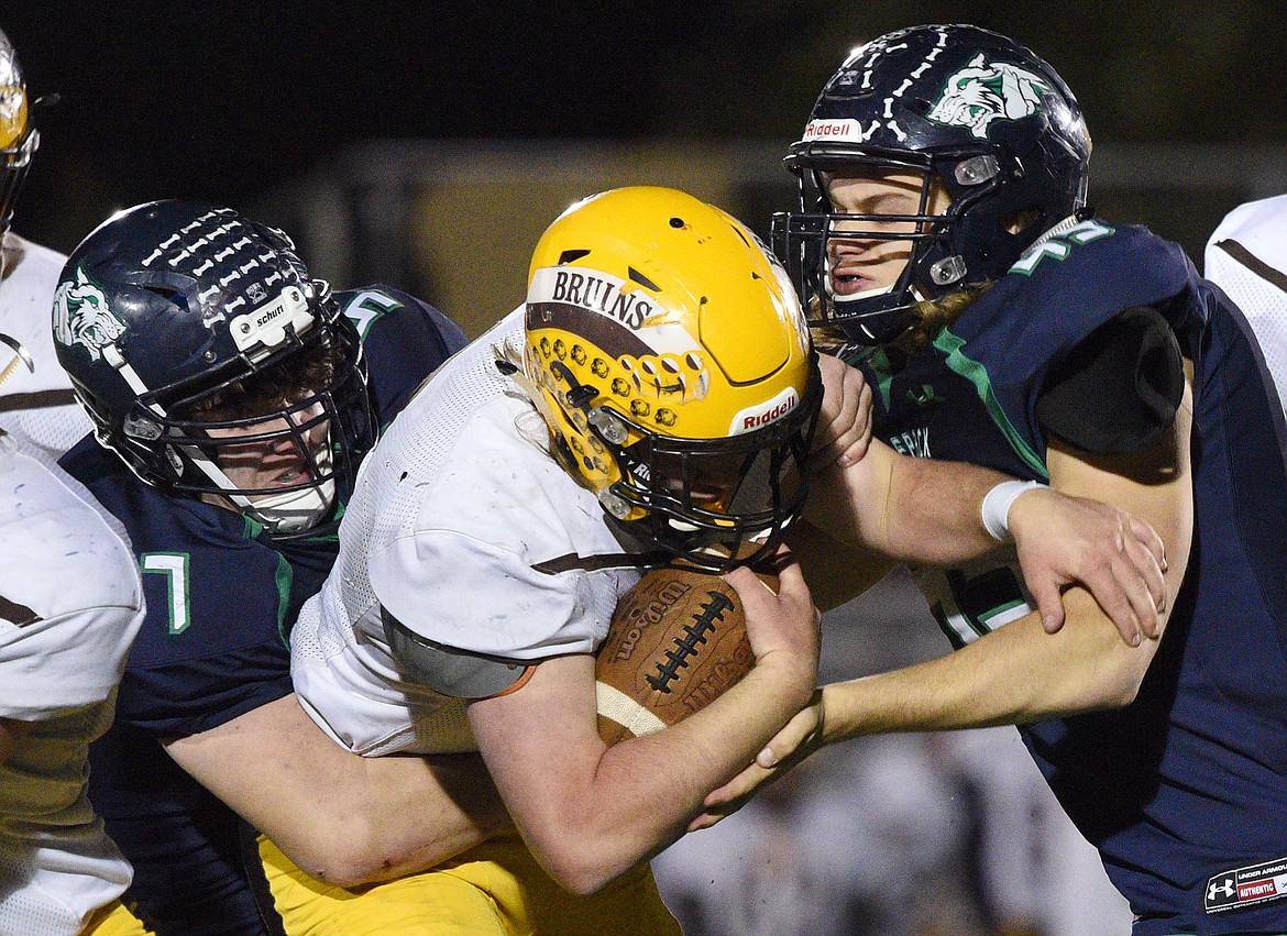 Glacier's Henry Nuce (57) and Ethan Baines (45) wrap up Helena Capital running back Brennan Casey (2) on a third quarter run at Legends Stadium on Friday. (Casey Kreider/Daily Inter Lake)