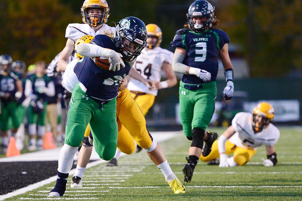 Glacier running back Preston Blain (33) fights for extra yardage on a first-quarter run against Helena Capital at Legends Stadium on Friday. (Casey Kreider/Daily Inter Lake)