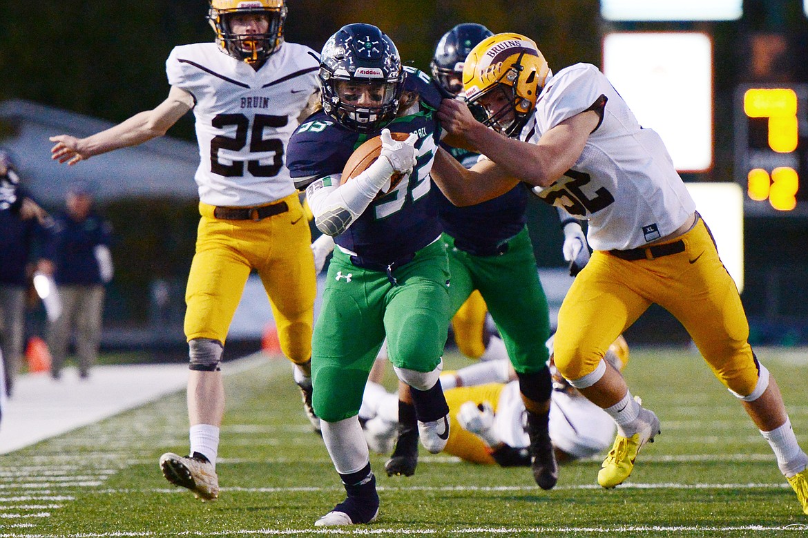 Glacier running back Preston Blain (33) fights for extra yardage on a first-quarter run against Helena Capital at Legends Stadium on Friday. (Casey Kreider/Daily Inter Lake)