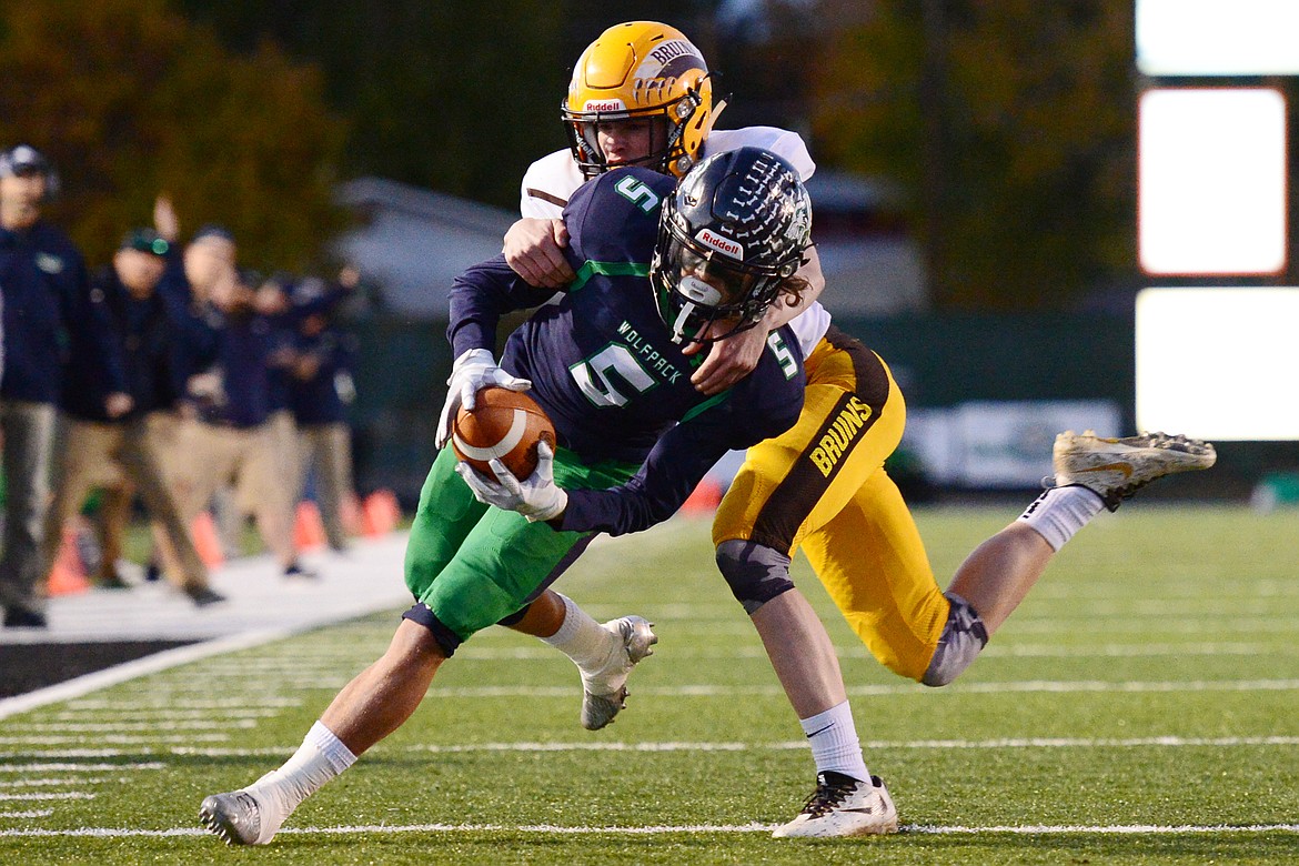 Glacier wide receiver Drew Deck (5) gets stopped short of the end zone by Helena Capital defensive back Gus Hanson (33) on a first-quarter reception at Legends Stadium on Friday. (Casey Kreider/Daily Inter Lake)