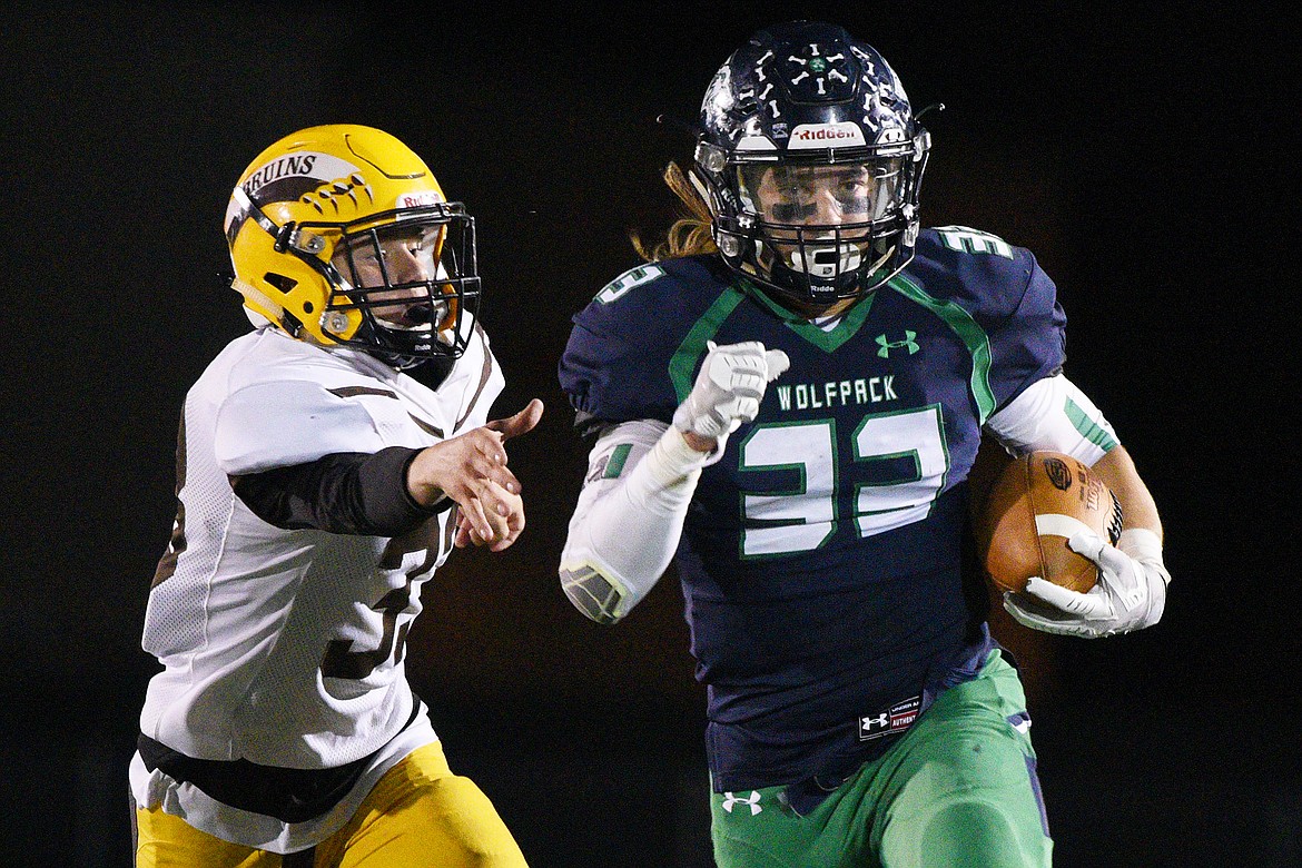 Glacier running back Preston Blain (33) gets past Helena Capital defensive back Will Butler (33) on a third quarter run at Legends Stadium on Friday. (Casey Kreider/Daily Inter Lake)